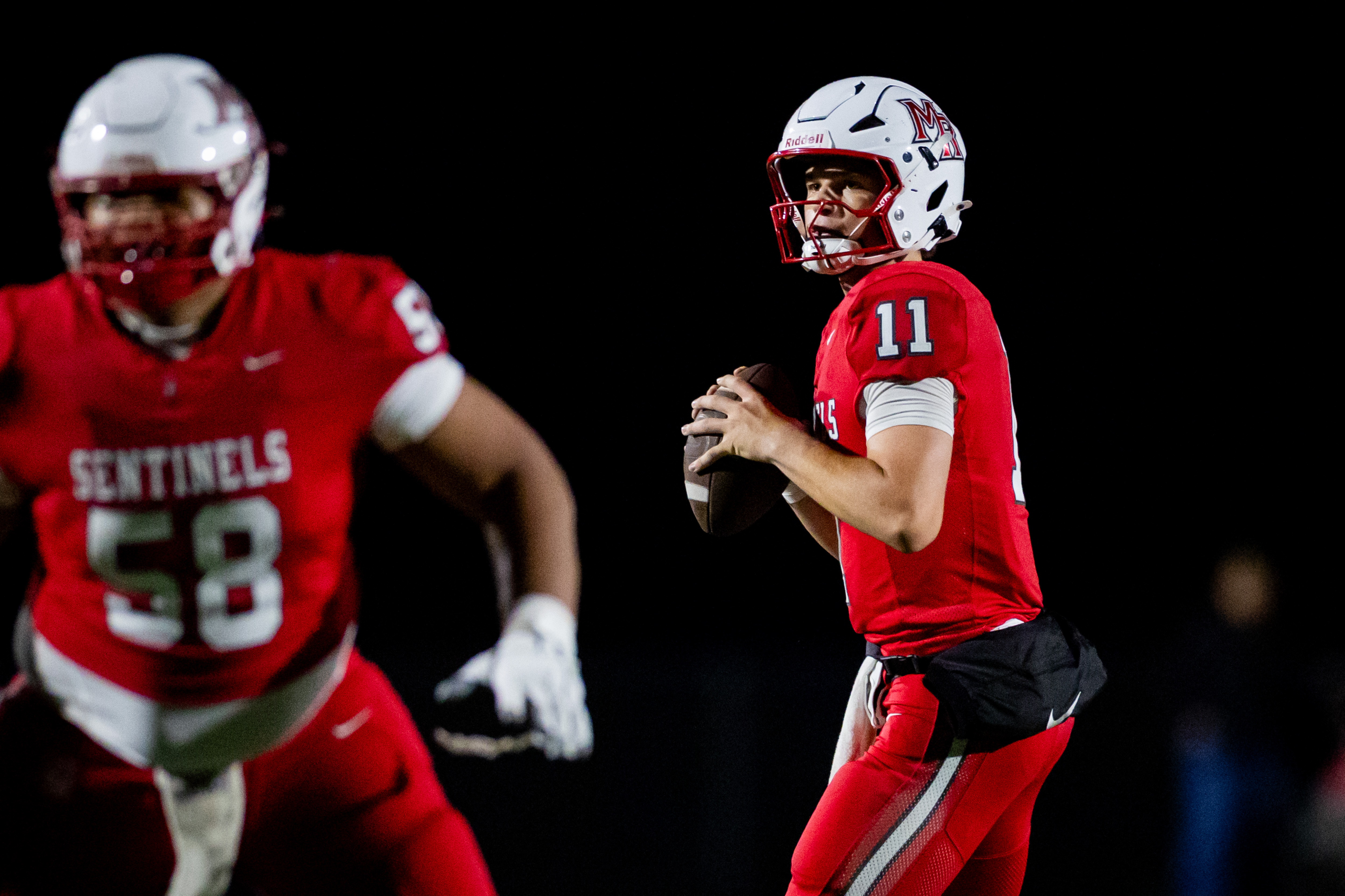 Mountain Ridge Sentinels quarterback Jaxon Hunt (11) prepares to throw the ball during a 6A high school football game against the Skyridge Falcons at Mountain Ridge High School  in Herriman on Thursday, Aug. 13, 2026.