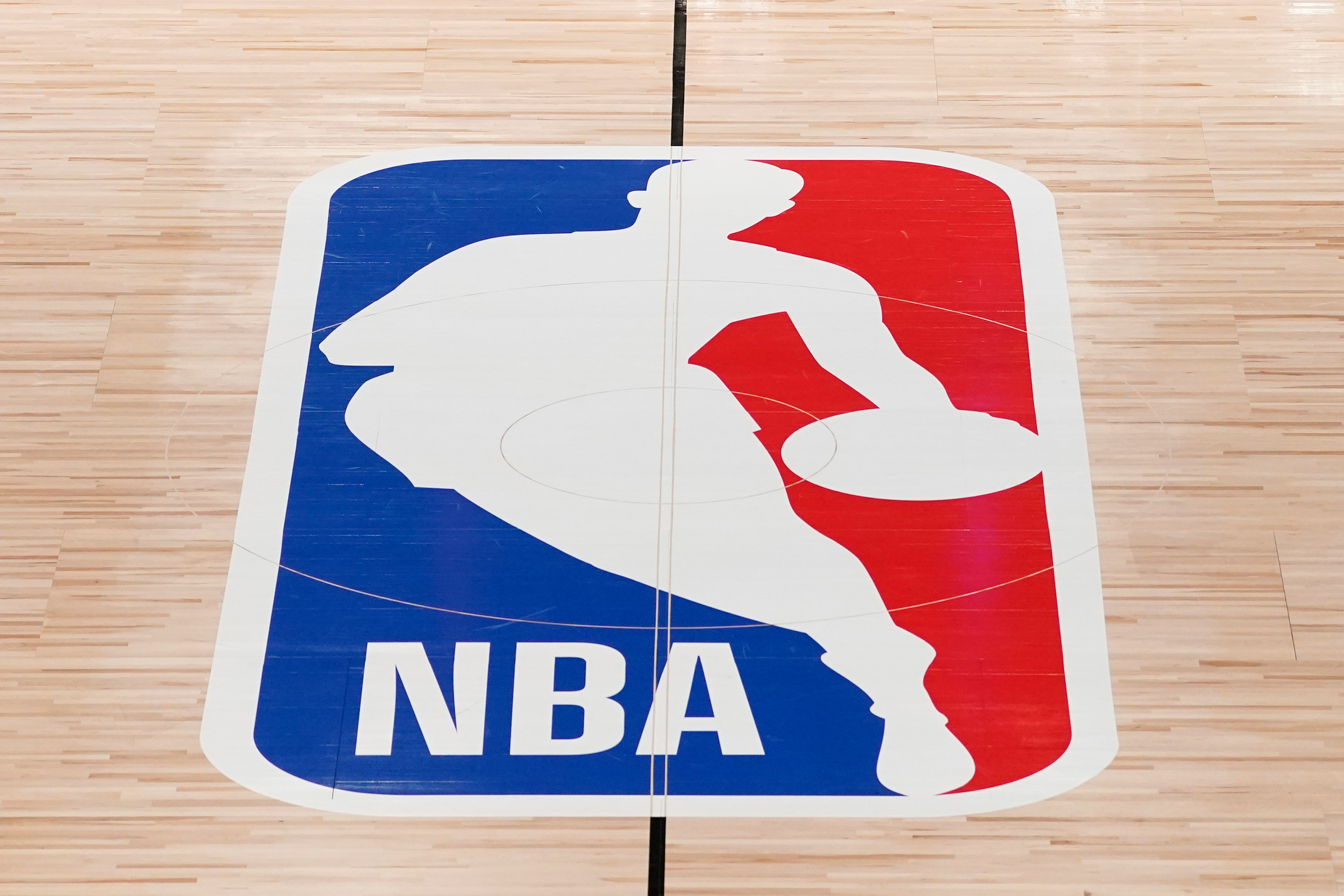 FILE - The NBA logo in shown on a basketball court in Lake Buena Vista, Fla., on Aug. 28, 2020. 