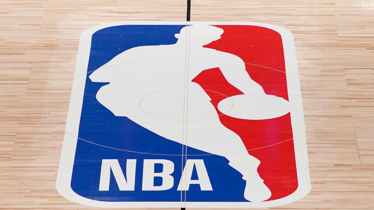 FILE - The NBA logo in shown on a basketball court in Lake Buena Vista, Fla., on Aug. 28, 2020.