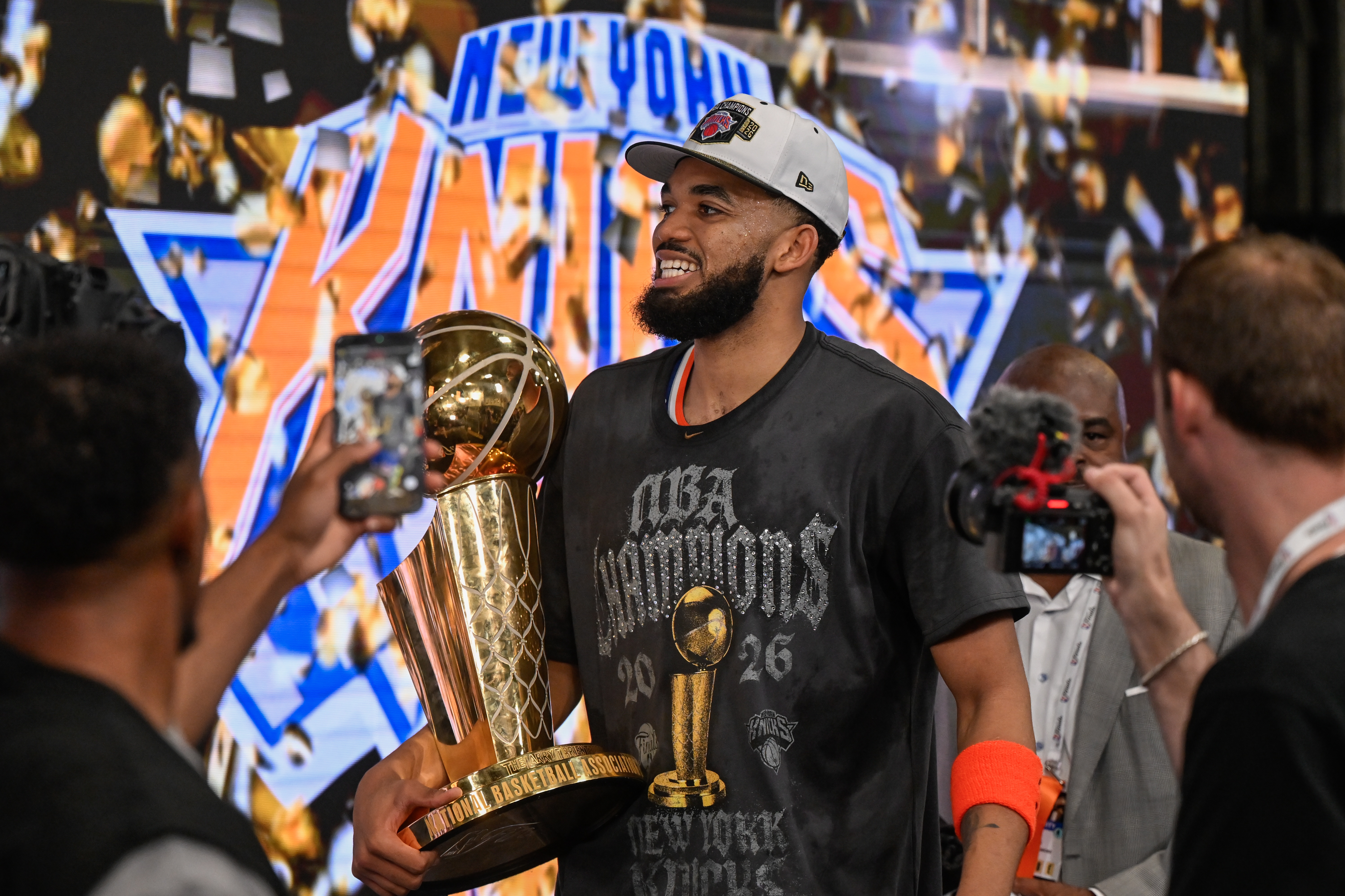 FILE - New York Knicks center Karl-Anthony Towns carries the Larry O'Brien Championship Trophy after the team defeated the San Antonio Spurs in Game 5 of the NBA Finals basketball series June 13, 2026, in San Antonio. 