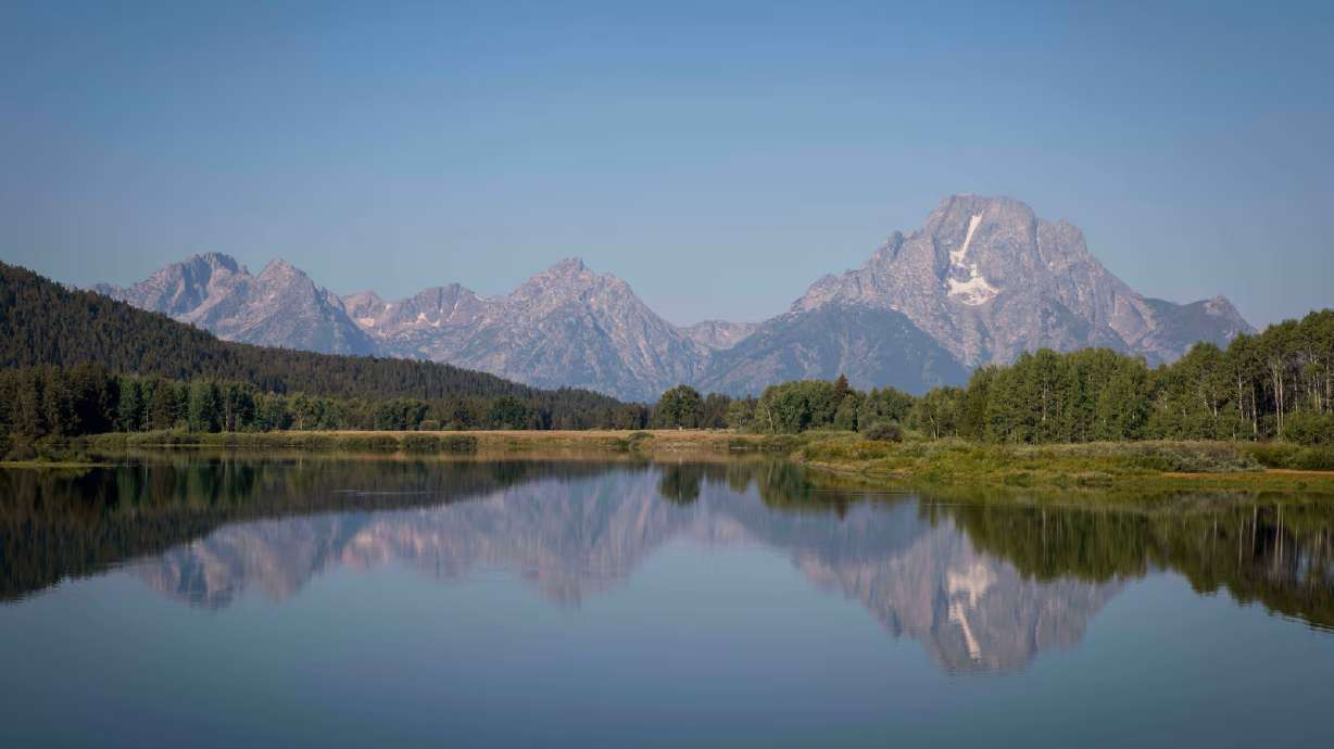 The Teton mountains reflect on Oxbow Bend in Grand Teton National Park in Moran, Wyo., on Friday, Aug. 22, 2025. Major League Baseball scrapped a proposal to build a stadium in the park for a regular-season game amid backlash from Wyoming leaders and residents.