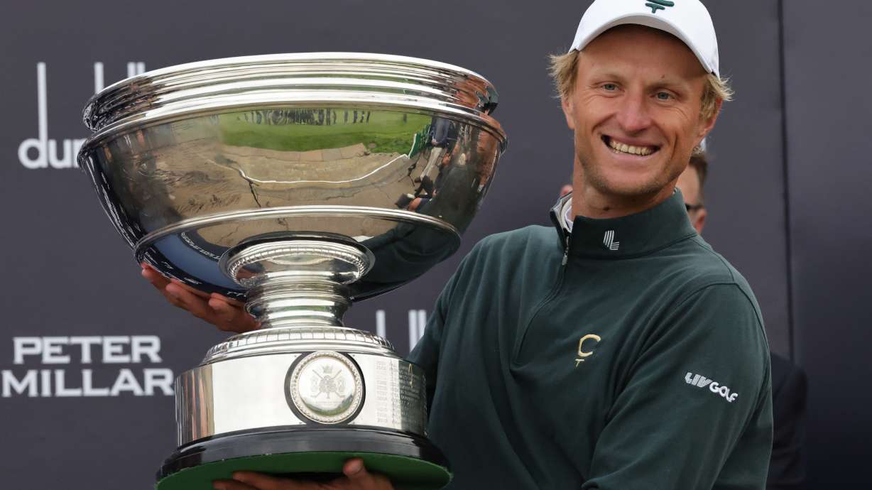 Adrian Meronk of Poland holds the trophy after winning the Alfred Dunhill Links Championship 2026 at the Old Course at St Andrews, Scotland, Sunday Oct. 4, 2026.
