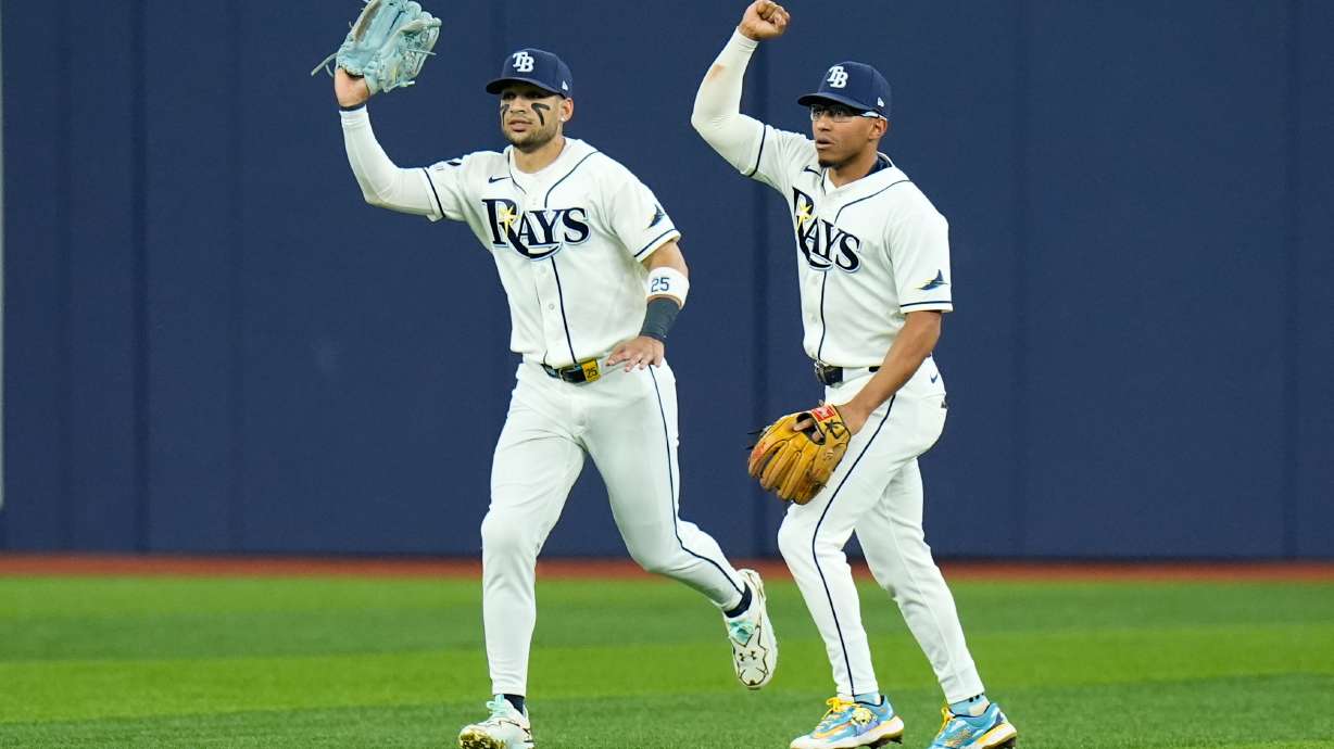 Tampa Bay Rays right fielder Victor Mesa Jr., left, and Rays second baseman Richie Palacios, right, react after Mesa Jr. caught a fly ball hit by New York Yankees' Spencer Jones that hit the ceiling of Tropicana Field for an out during the second inning in Game 2 of an American League Division Series baseball game Monday, Oct. 5, 2026, in St. Petersburg, Fla.