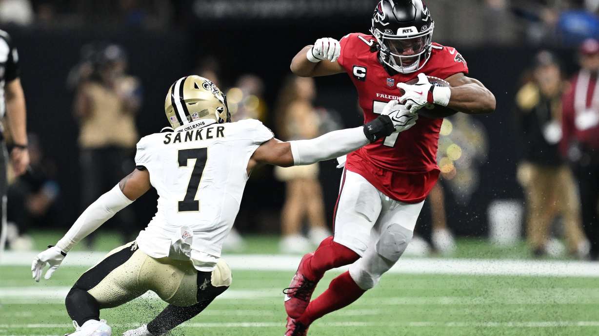 Atlanta Falcons running back Bijan Robinson, right, runs against New Orleans Saints safety Jonas Sanker during the first half of an NFL football game in New Orleans, Monday, Oct. 5, 2026.