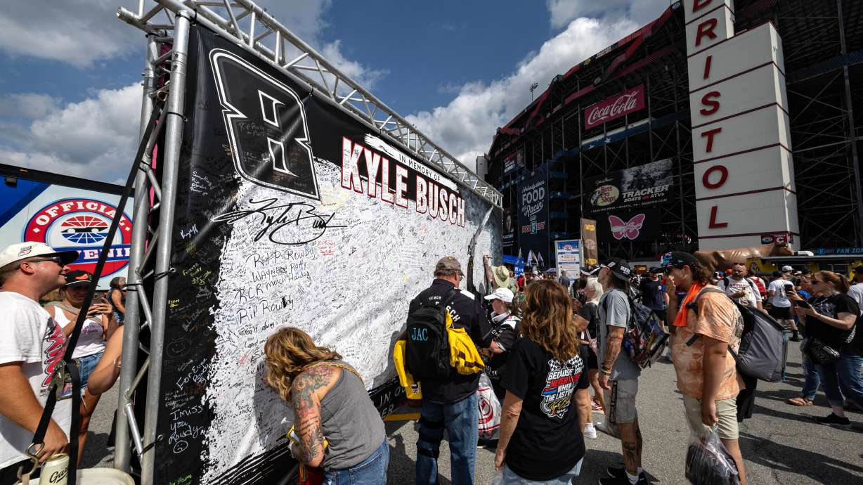 Fans signs their name to a tribute sign to the late Kyle Busch before a NASCAR Cup Series auto race Saturday, Sept. 19, 2026, in Bristol, Tenn.