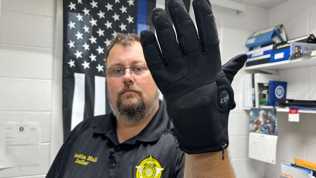 Nelson County, Ky., jailer Justin Hall shows an electric shock glove that is used at his facility, Aug. 13, 2026, in Bardstown, Ky.