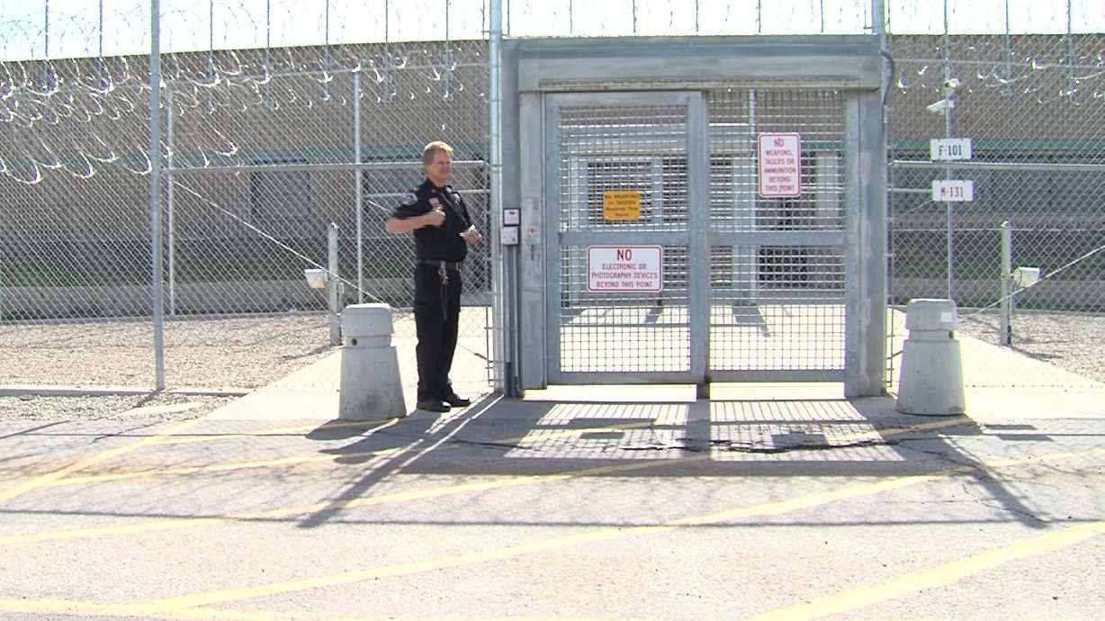 A corrections worker stands by the gate of the Utah State Prison. (File)