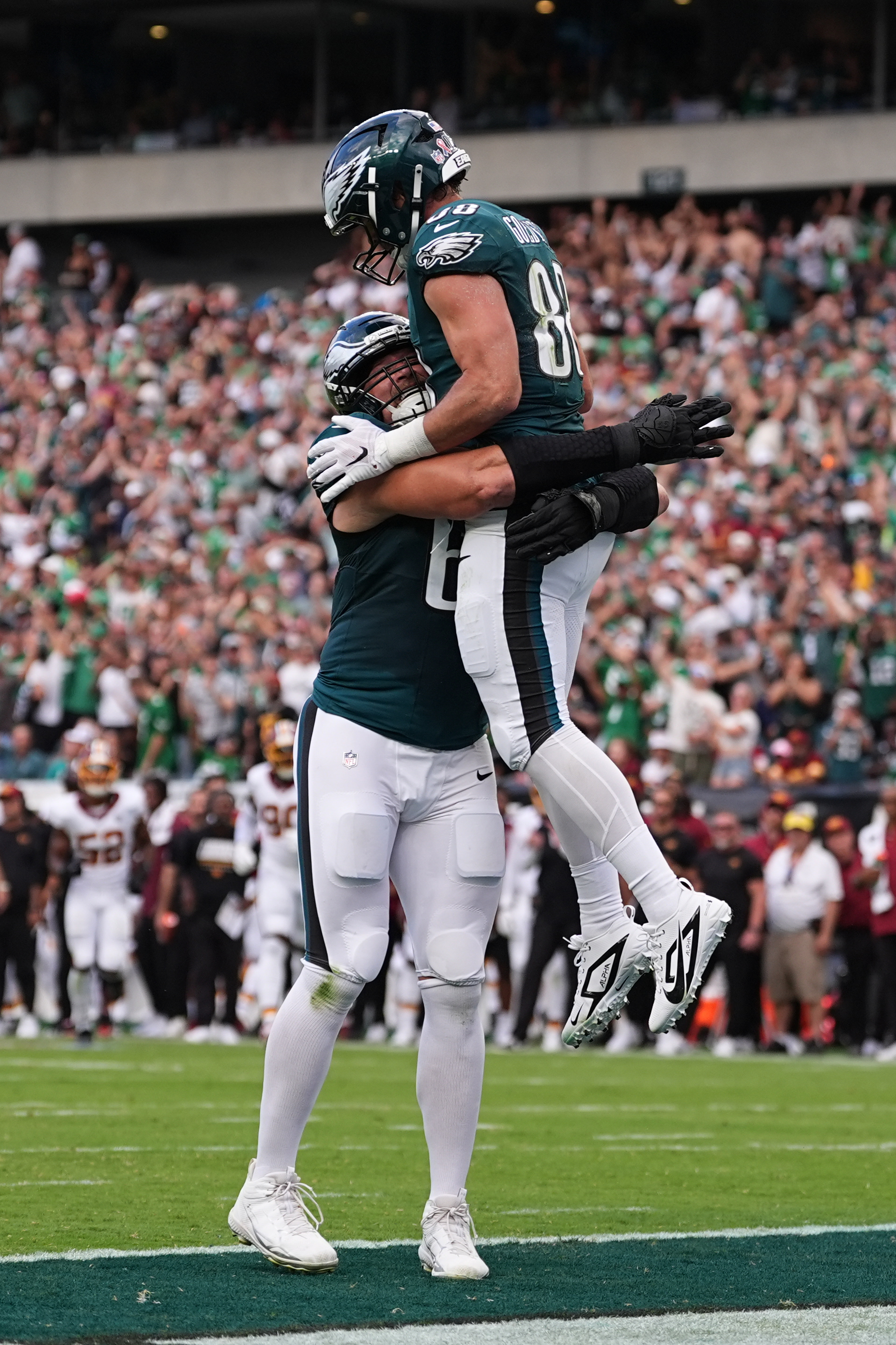 Philadelphia Eagles tight end Dallas Goedert (88) celebrates his touchdown catch with teammate Lane Johnson (65) during the first half of an NFL football game, Sunday, Sept. 13, 2026, in Philadelphia. 