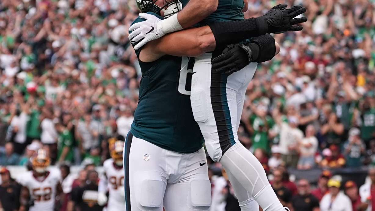Philadelphia Eagles tight end Dallas Goedert (88) celebrates his touchdown catch with teammate Lane Johnson (65) during the first half of an NFL football game, Sunday, Sept. 13, 2026, in Philadelphia.