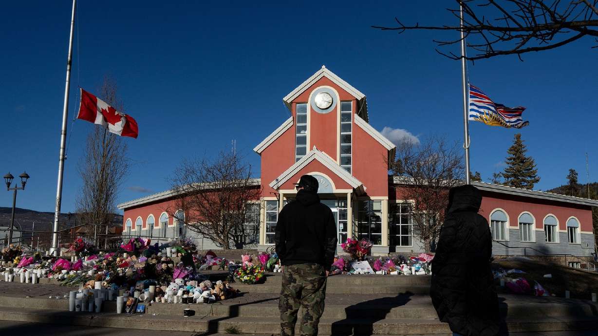 People pay their respects at a memorial on the steps of the Town Hall, following a vigil the previous day, in Tumbler Ridge, British Columbia, Canada, Feb. 14. U.S. authorities have arrested a 30-year-old from Washington state in connection with the February school shooting in Tumbler Ridge, British Columbia.