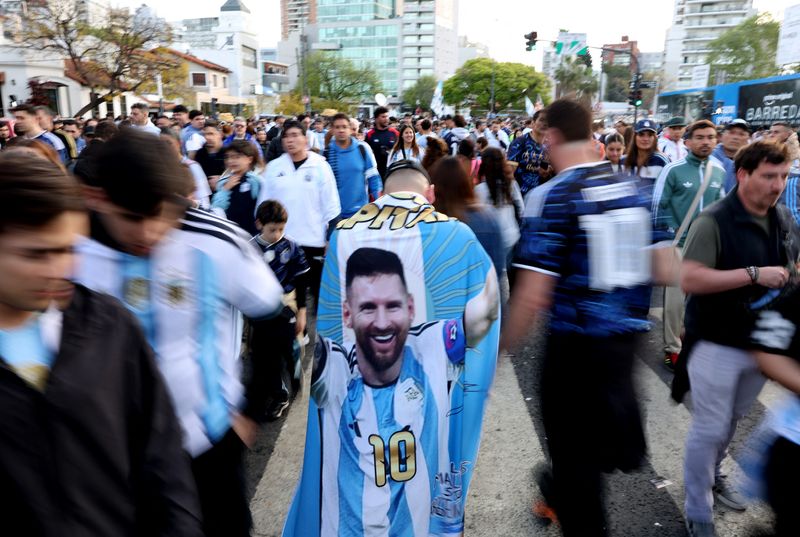 Soccer Football - International Friendly - Argentina v Benin - Estadio Monumental, Buenos Aires, Argentina - October 6, 2026 An Argentina fan with a flag of Lionel Messi outside the stadium before the match