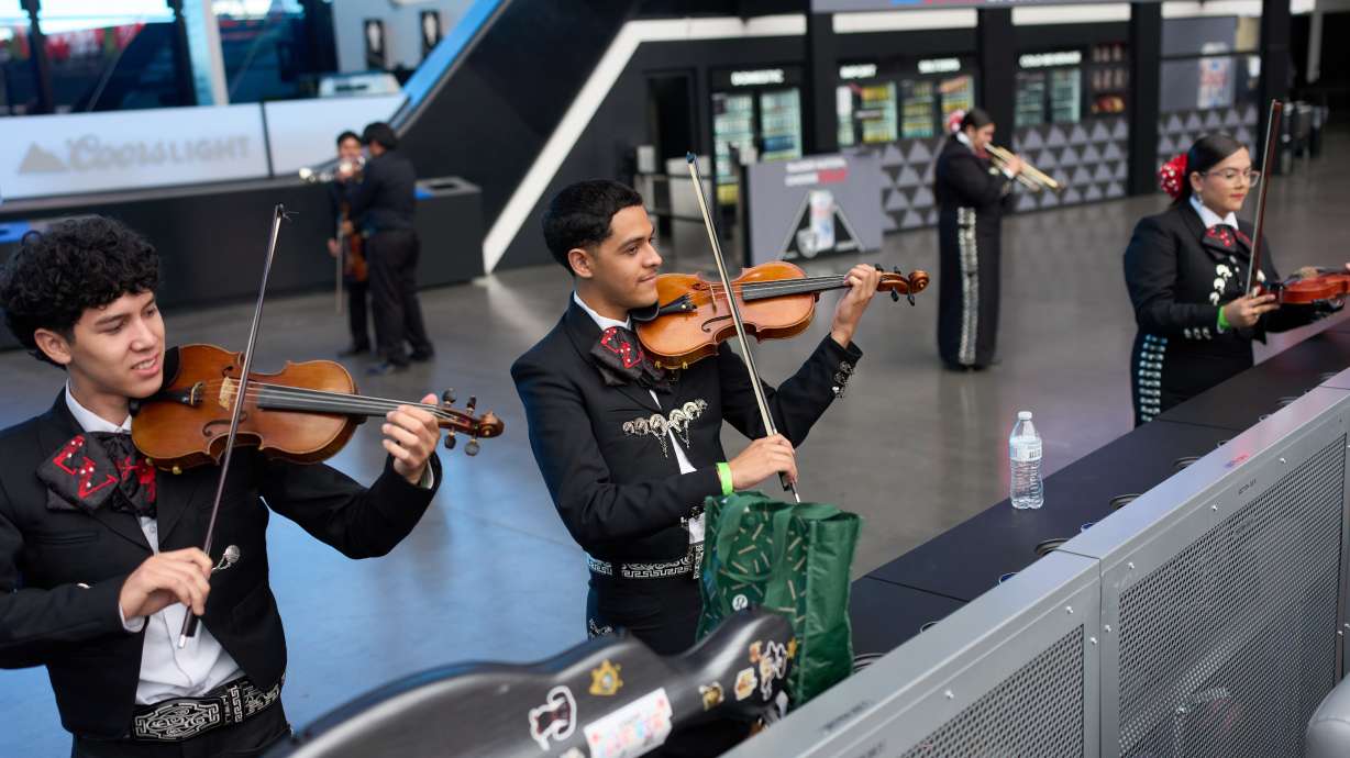 Axel Rodríguez Olivas, center, and Blanier Bojorquez, left, warm up with other University of Nevada, Las Vegas mariachi students before performing Oct. 3, in Las Vegas.
