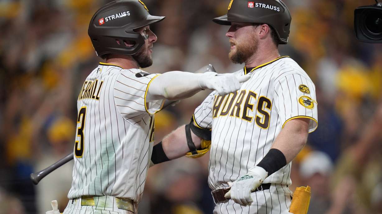 San Diego Padres' Jake Cronenworth, right, is congratulated by teammate Jackson Merrill (3) after hitting a solo home run during the fifth inning in Game 3 of baseball's National League Division Series against the Milwaukee Brewers Tuesday, Oct. 6, 2026, in San Diego.