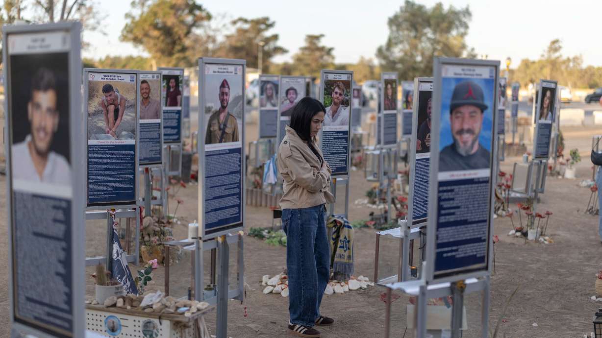An Israeli woman pays her respects at a memorial to the victims of the 2023 Hamas attacks at the Nova festival site in Reim, southern Israel, on Tuesday. Israel marked the somber occasion with a series of ceremonies, memorials and protests at more than 400 locations.
