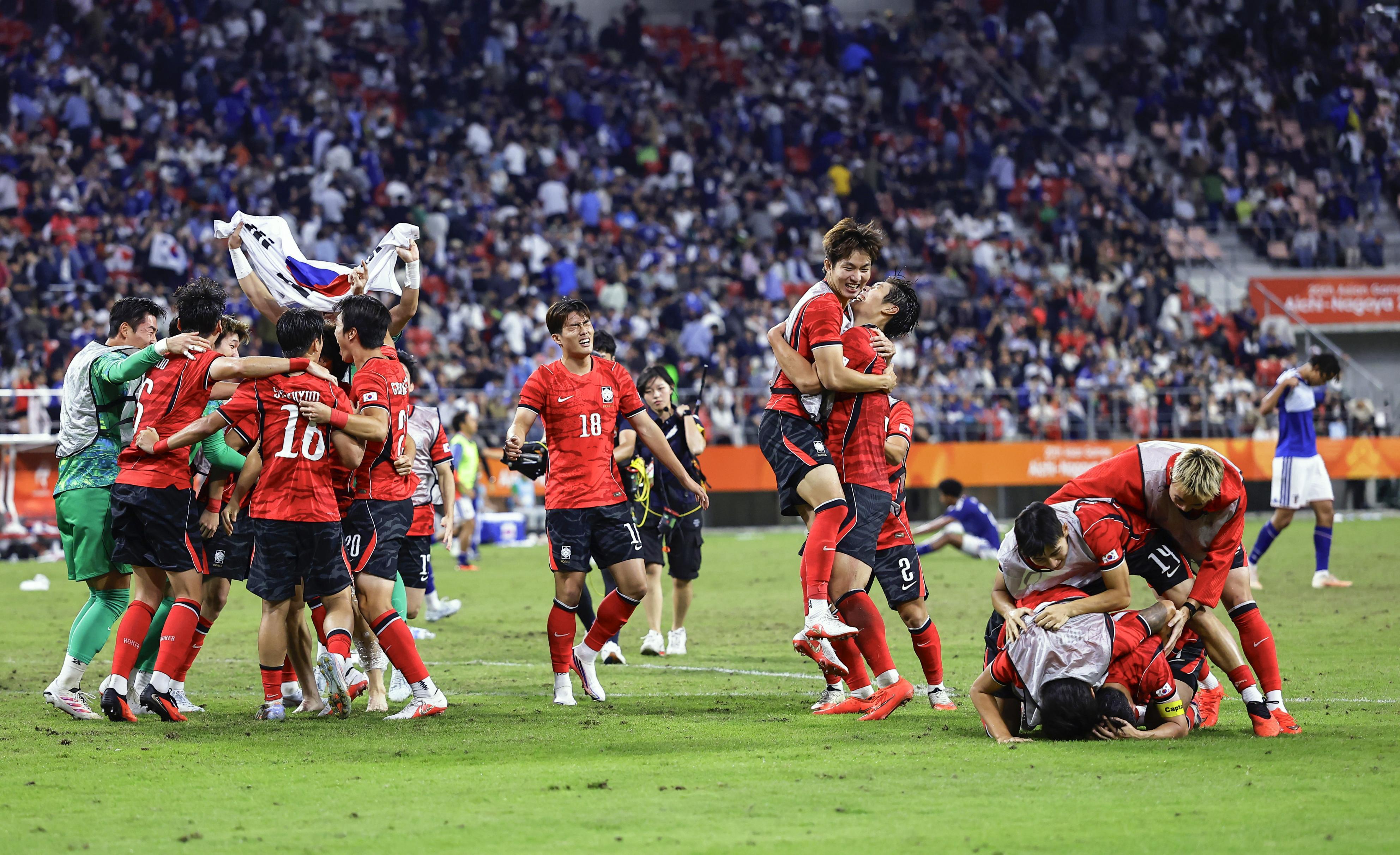 South Korea's team members celebrate as they defeated Japan in the men’s final in football at the Asian Games in Toyota, central Japan, Saturday, Oct. 3, 2026. 