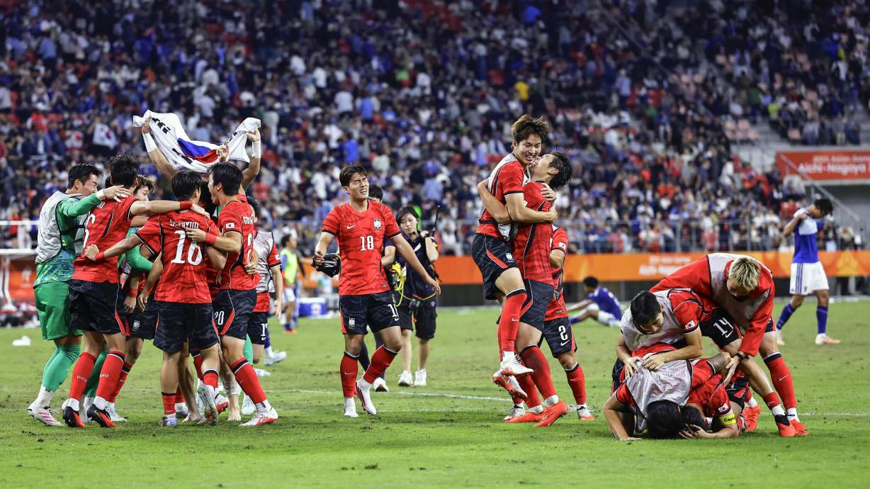 South Korea's team members celebrate as they defeated Japan in the men’s final in football at the Asian Games in Toyota, central Japan, Saturday, Oct. 3, 2026.
