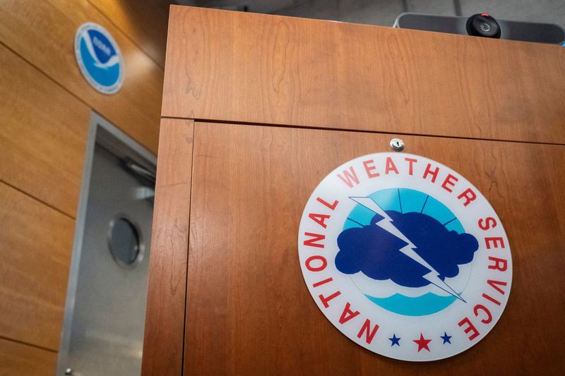 FILE PHOTO: The National Weather Service logo is displayed at the National Hurricane Center (NHC) during a news conference in Miami, Florida, U.S. May 30, 2025.