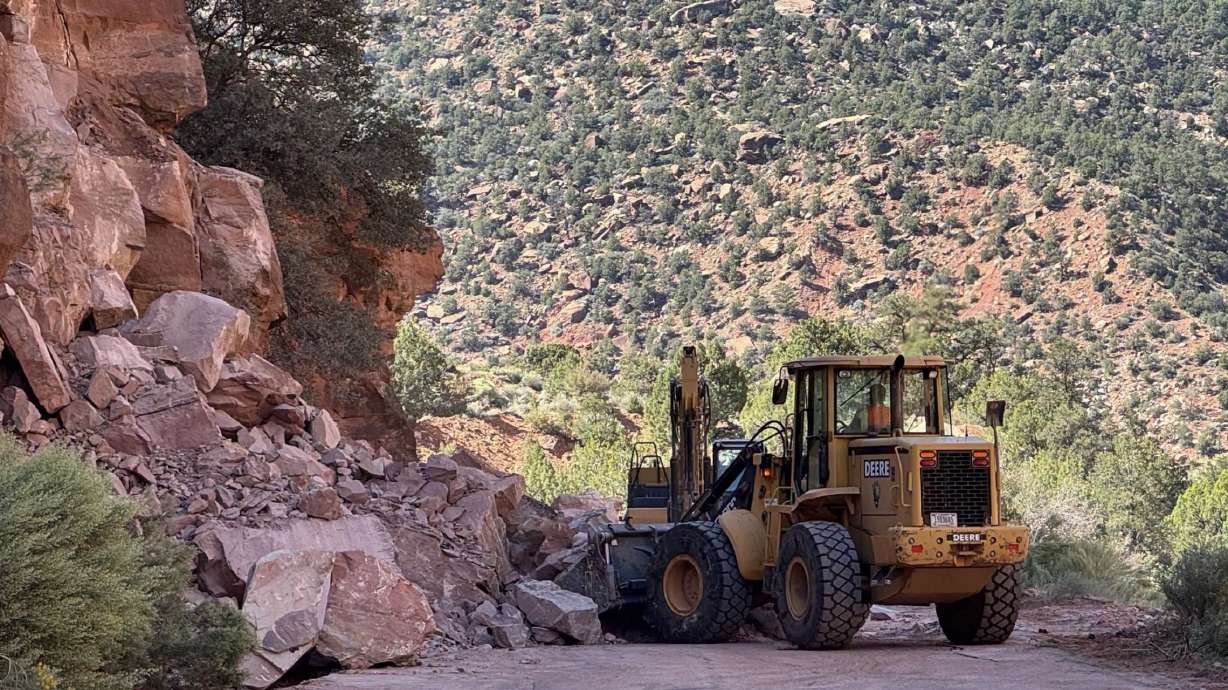 Crews clean up debris from a rockfall that happened along Zion-Mt. Carmel Highway in Zion National Park on Sept. 30. A 7.5-mile section reopened on Tuesday, but another 2.5-mile section could remain closed for "several weeks," park officials warn.