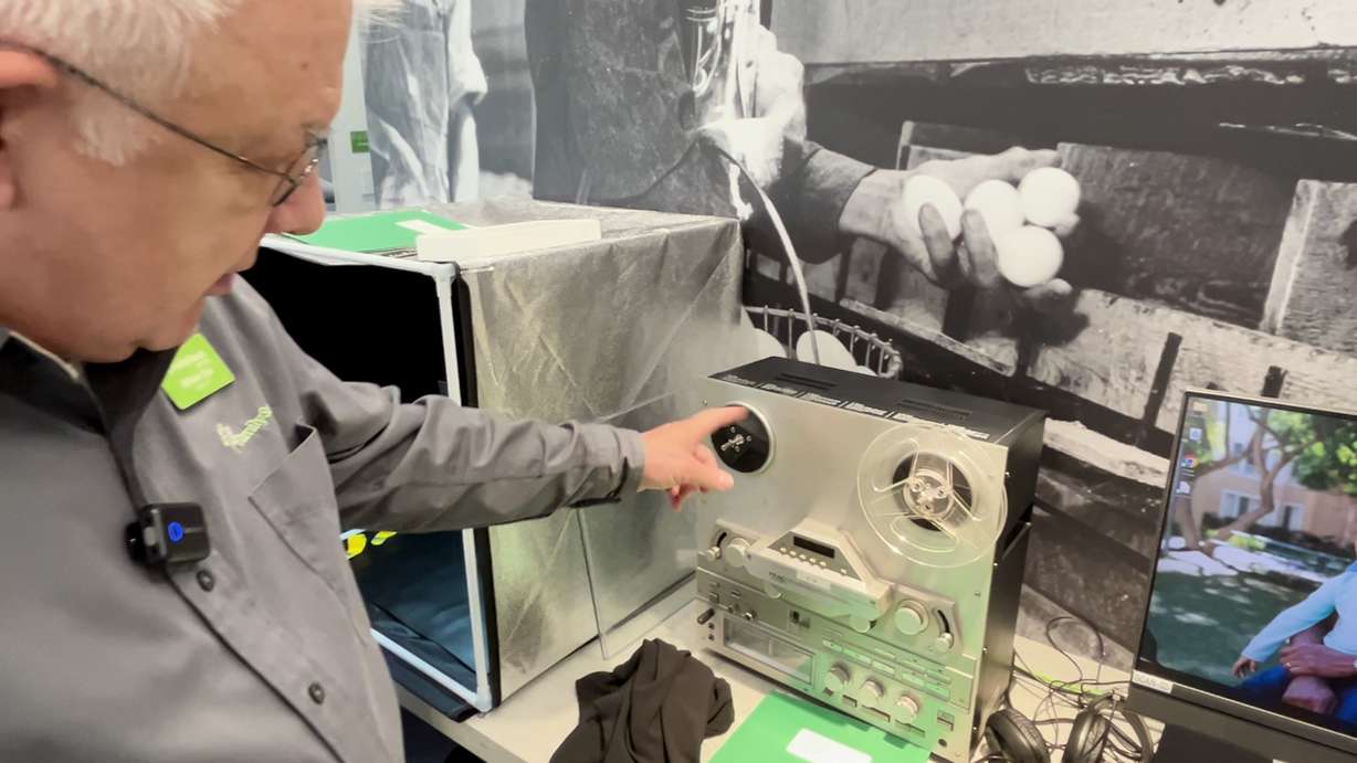 Coordinator Bill Cox shows some of the equipment used to digitize and modernize historical records and photos, including this reel-to-reel tape machine.