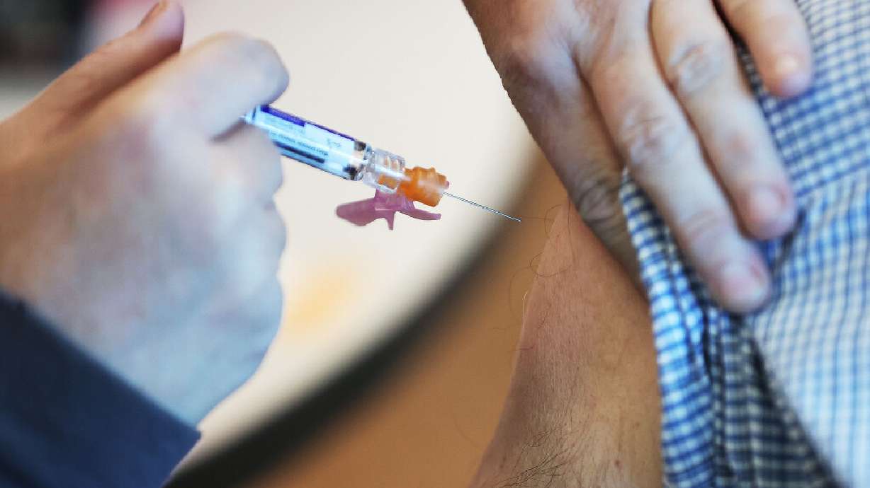 A flu vaccine is given during the Halloween Scare fair at the Community Health Center Neighborhood Clinic in Salt Lake City on Friday, Oct. 28, 2022.