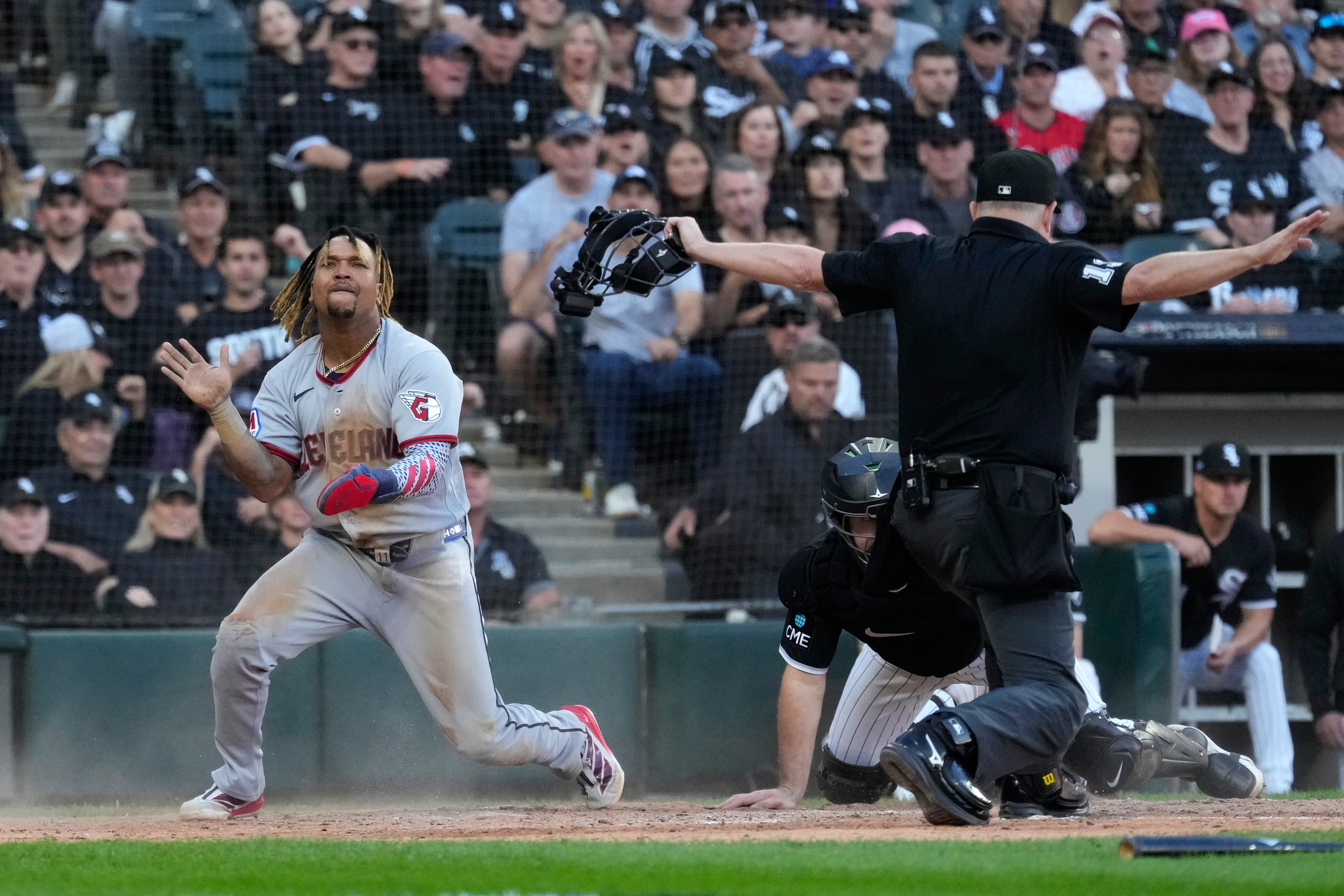 Cleveland Guardians' José Ramírez, left, celebrates after scoring on a fielder's choice by Chase DeLauter during the fifth inning in Game 3 of baseball's American League Division Series against the Chicago White Sox Wednesday, Oct. 7, 2026, in Chicago. 