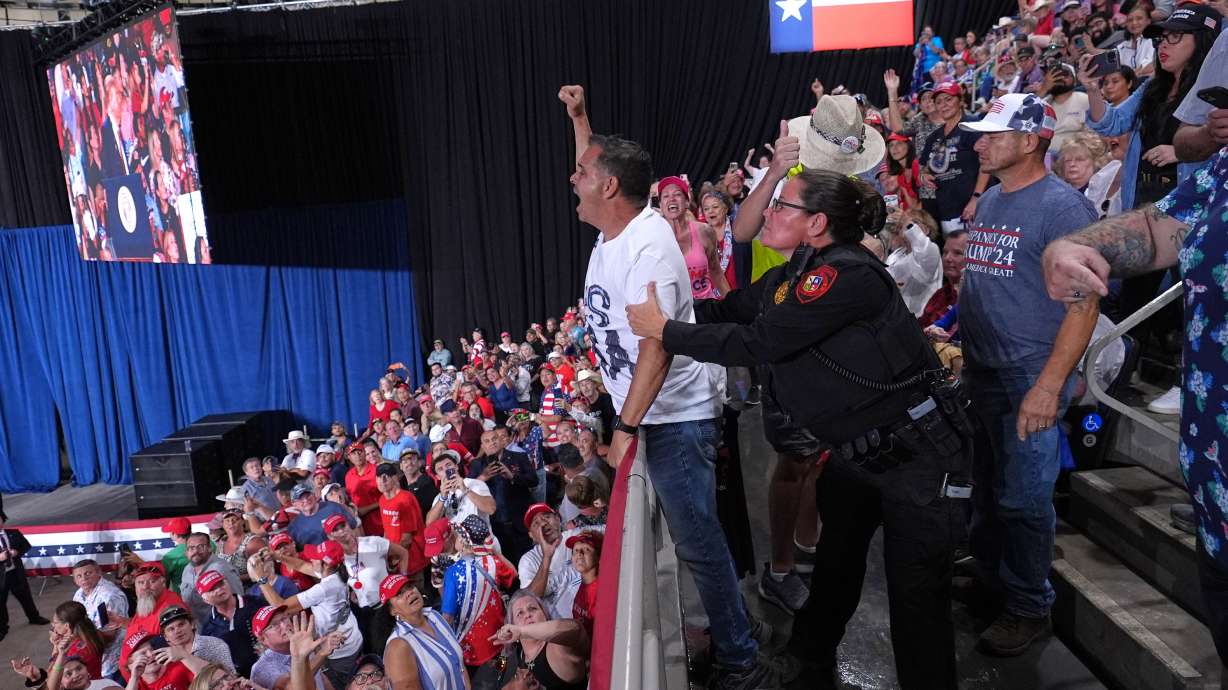Police remove a protester as President Donald Trump speaks at a campaign rally at the Freeman Coliseum in San Antonio, Wednesday. President Trump, facing protesters and a poor political climate, fought to rally Texas voters behind embattled Senate candidate Ken Paxton on Wednesday night.