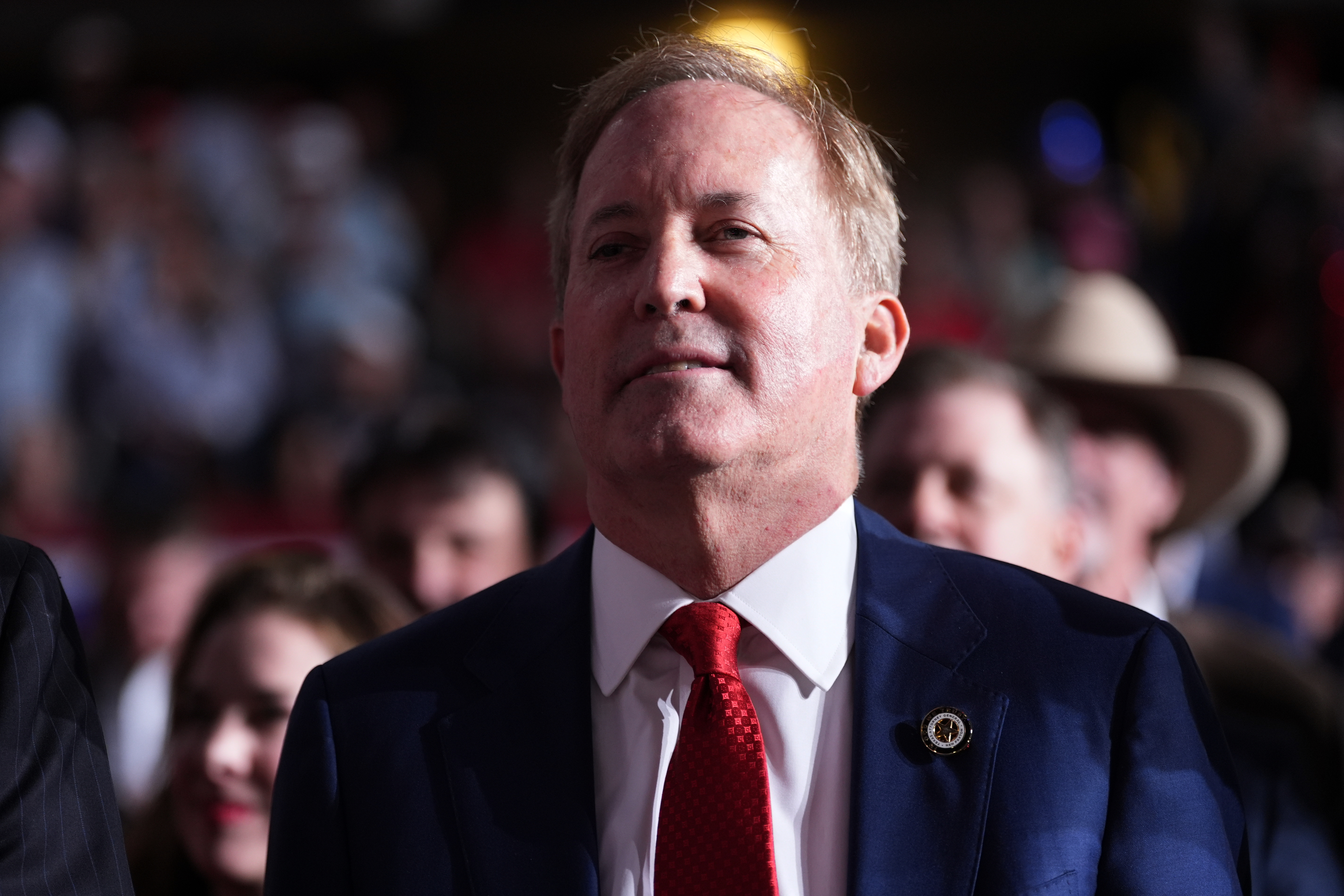 Republican U.S. Senate candidate Texas Attorney General Ken Paxton listens as President Donald Trump speaks at a campaign rally at the Freeman Coliseum in San Antonio, Wednesday.