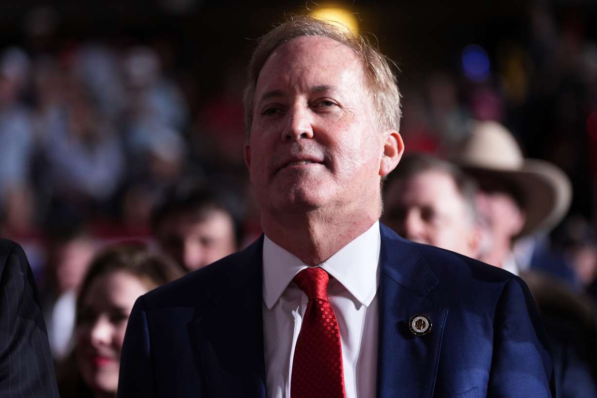Republican U.S. Senate candidate Texas Attorney General Ken Paxton listens as President Donald Trump speaks at a campaign rally at the Freeman Coliseum in San Antonio, Wednesday.