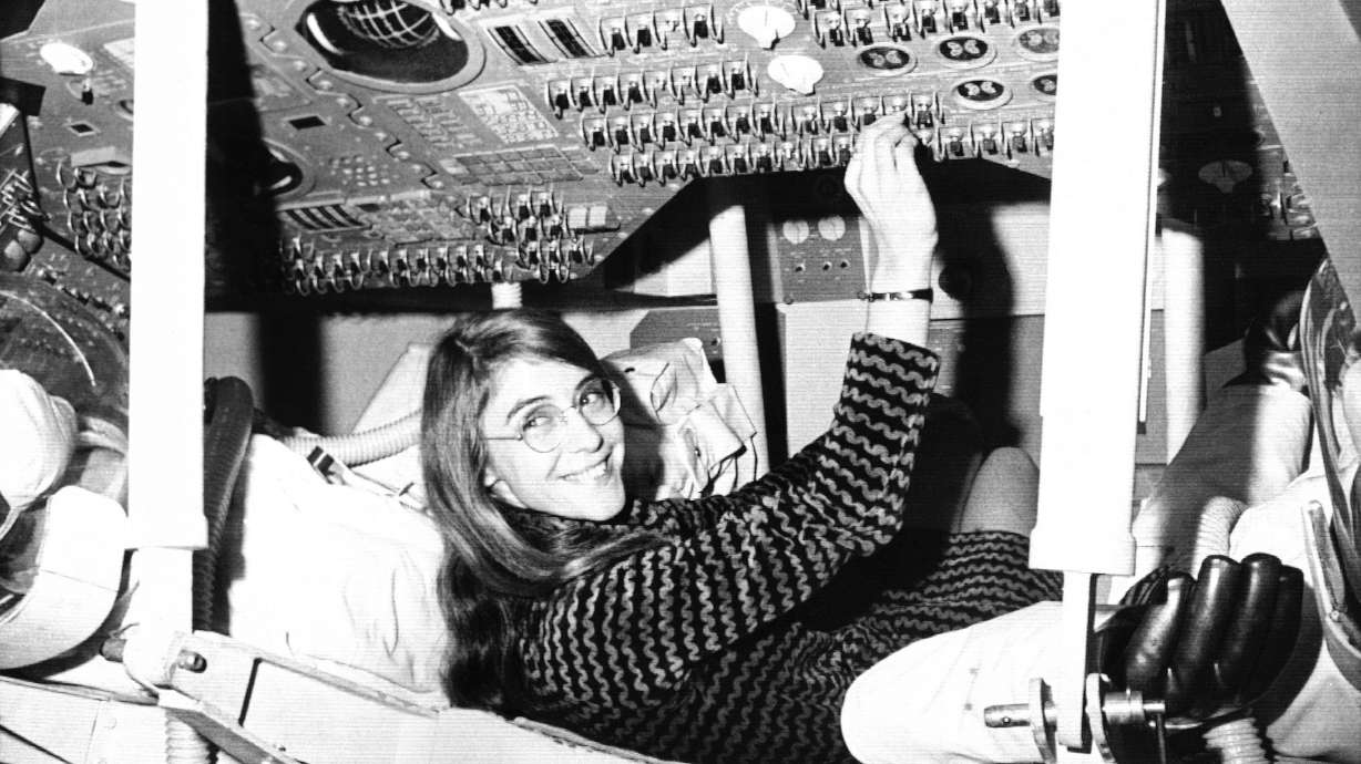 Margaret Hamilton sits in mock-up of an Apollo command module on display at the Cambridge school, Nov. 25, 1969, where she headed the group that programmed the Intrepid spacecraft's pinpoint landing on the moon.
