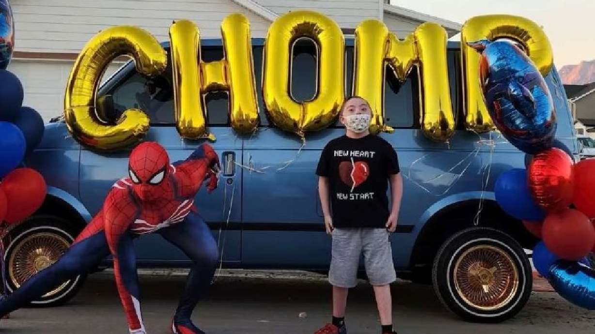 Brandon Barela, also known as "Chomp," stands alongside Spider-Man after leaving Intermountain Primary Children's Hospital on Thursday.