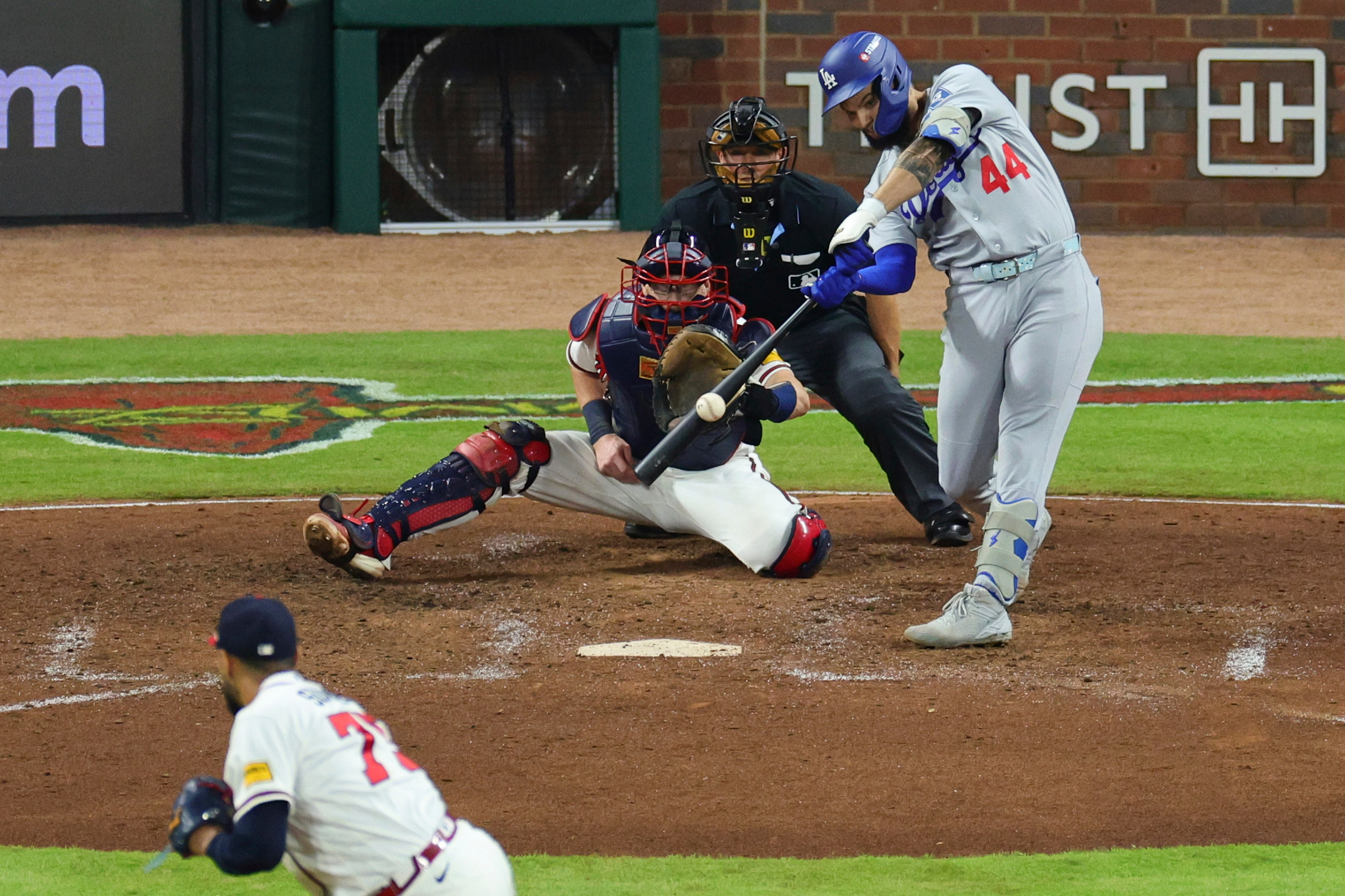 Los Angeles Dodgers center fielder Andy Pages (44) hits a two run RBI-single off a pitch by Atlanta Braves pitcher Didier Fuentes, bottom left, during the seventh inning in Game 4 of baseball's National League Division Series, Wednesday, Oct. 7, 2026, in Atlanta. 