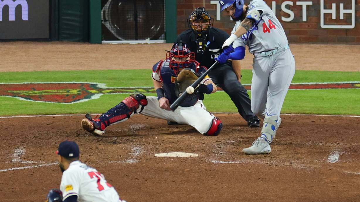 Los Angeles Dodgers center fielder Andy Pages (44) hits a two run RBI-single off a pitch by Atlanta Braves pitcher Didier Fuentes, bottom left, during the seventh inning in Game 4 of baseball's National League Division Series, Wednesday, Oct. 7, 2026, in Atlanta.