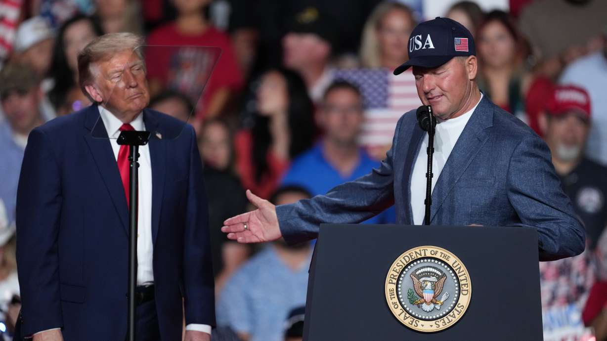 President Donald Trump listens as Roger Clemens speaks at a campaign rally at the Freeman Coliseum in San Antonio, Wednesday, Oct. 7, 2026.