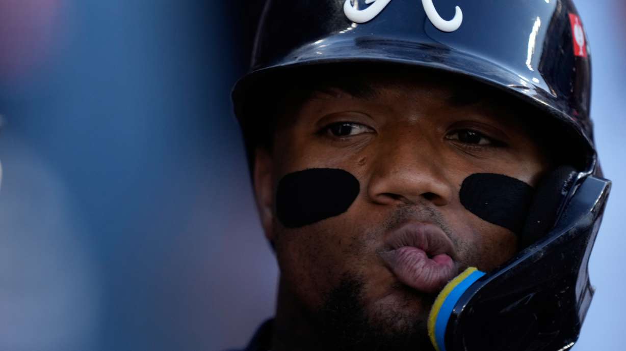 Atlanta Braves' Ronald Acuña Jr. celebrates with teammates after scoring off an RBI single by Mauricio Dubón during the first inning of Game 2 of a National League Division Series baseball game against the Los Angeles Dodgers Sunday, Oct. 4, 2026, in Los Angeles.