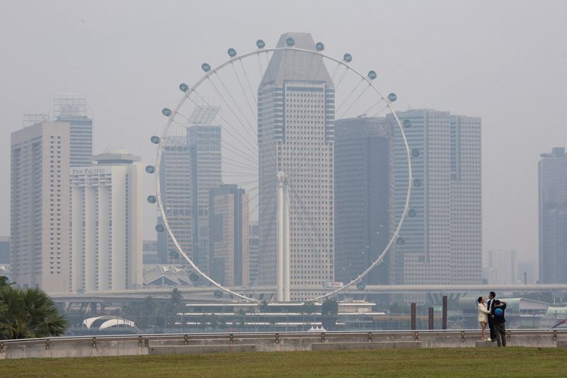FILE PHOTO: The Singapore Flyer and commercial buildings are shrouded in haze at the Marina Bay area in Singapore, September 15, 2026.