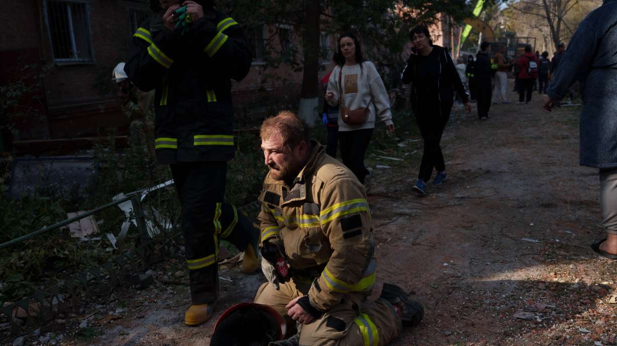A rescue worker sits on the ground next to a residential building destroyed in a Russian missile strike on Pryluky, Ukraine, Wednesday. Russian strikes in eastern Ukraine killed 30 people and injured at least 18, according to authorities on Thursday.