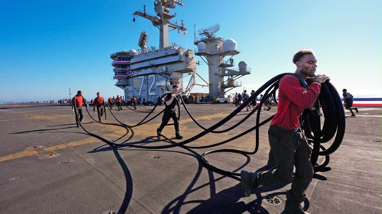 Crew members prepare the U.S.S. Abraham Lincoln (CVN 72) for return on Wednesday to her home port, Naval Air Station North Island in San Diego, Calif.