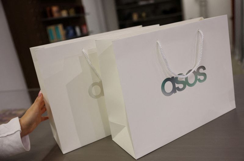 FILE PHOTO: Branded shopping bags are displayed in an ASOS pop-up store in London, Britain, November 12, 2025.