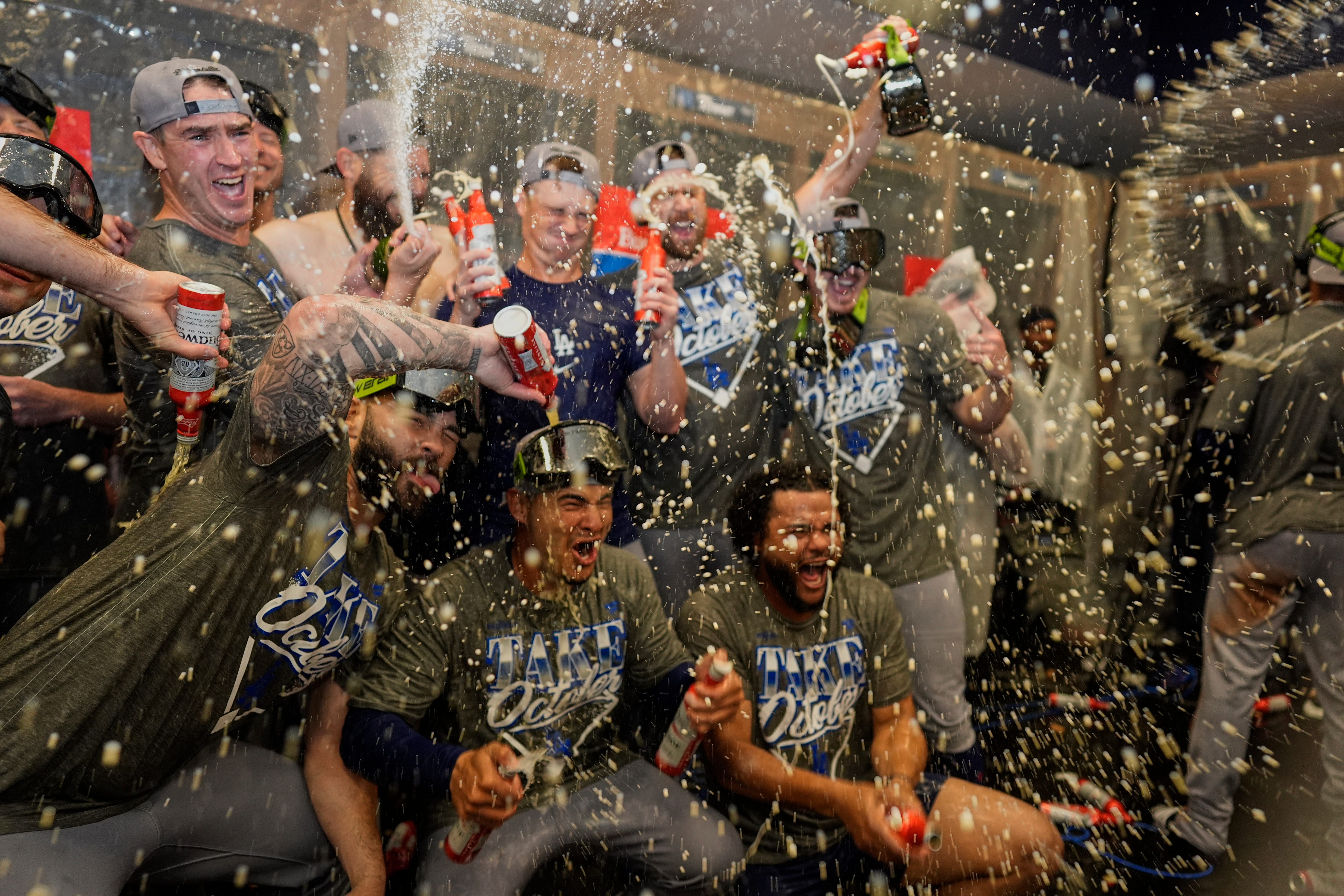 Los Angeles Dodgers players celebrate winning Game 4 of baseball's National League Division Series against the Atlanta Braves, Wednesday, Oct. 7, 2026, in Atlanta. 