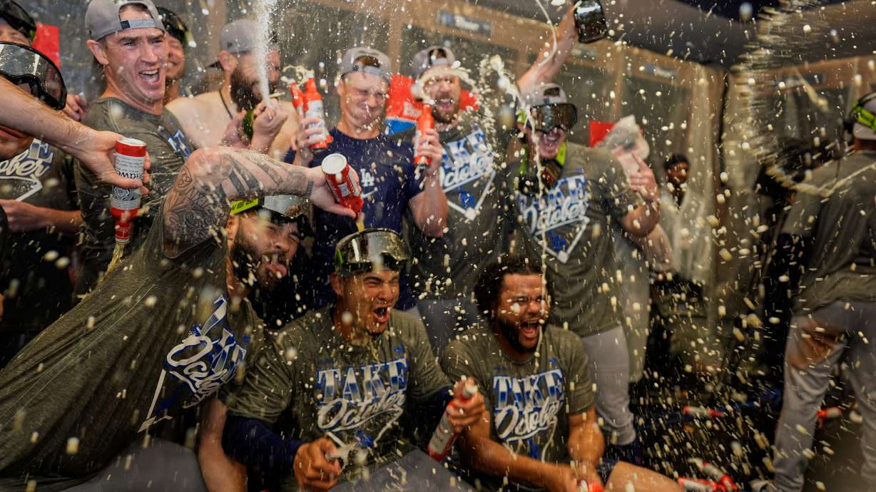 Los Angeles Dodgers players celebrate winning Game 4 of baseball's National League Division Series against the Atlanta Braves, Wednesday, Oct. 7, 2026, in Atlanta.