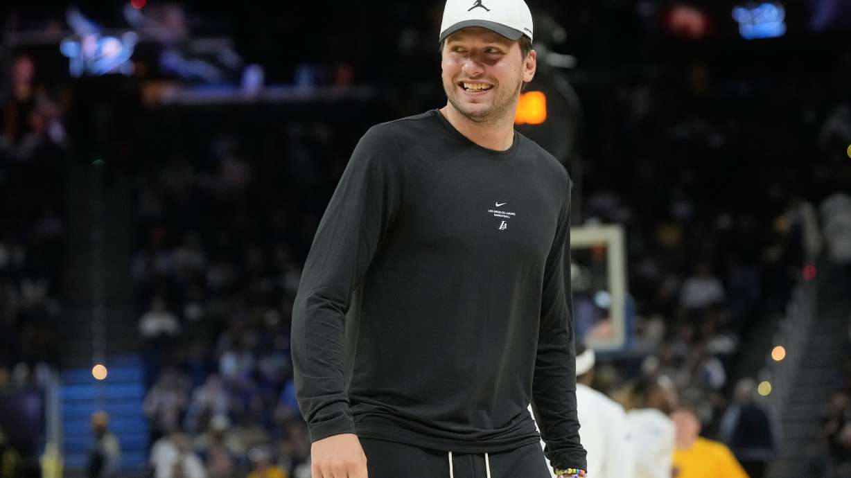 Los Angeles Lakers guard Luka Doncic smiles while walking on the floor during the second half of an NBA preseason basketball game against the Golden State Warriors, Tuesday, Oct. 6, 2026, in San Francisco.