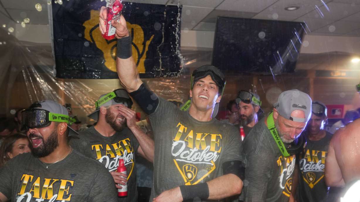 Milwaukee Brewers' Christian Yelich, center celebrates with teammates after the team defeated the San Diego Padres in Game 4 of baseball's National League Division Series Wednesday, Oct. 7, 2026, in San Diego, to advance to the National League Championship Series.