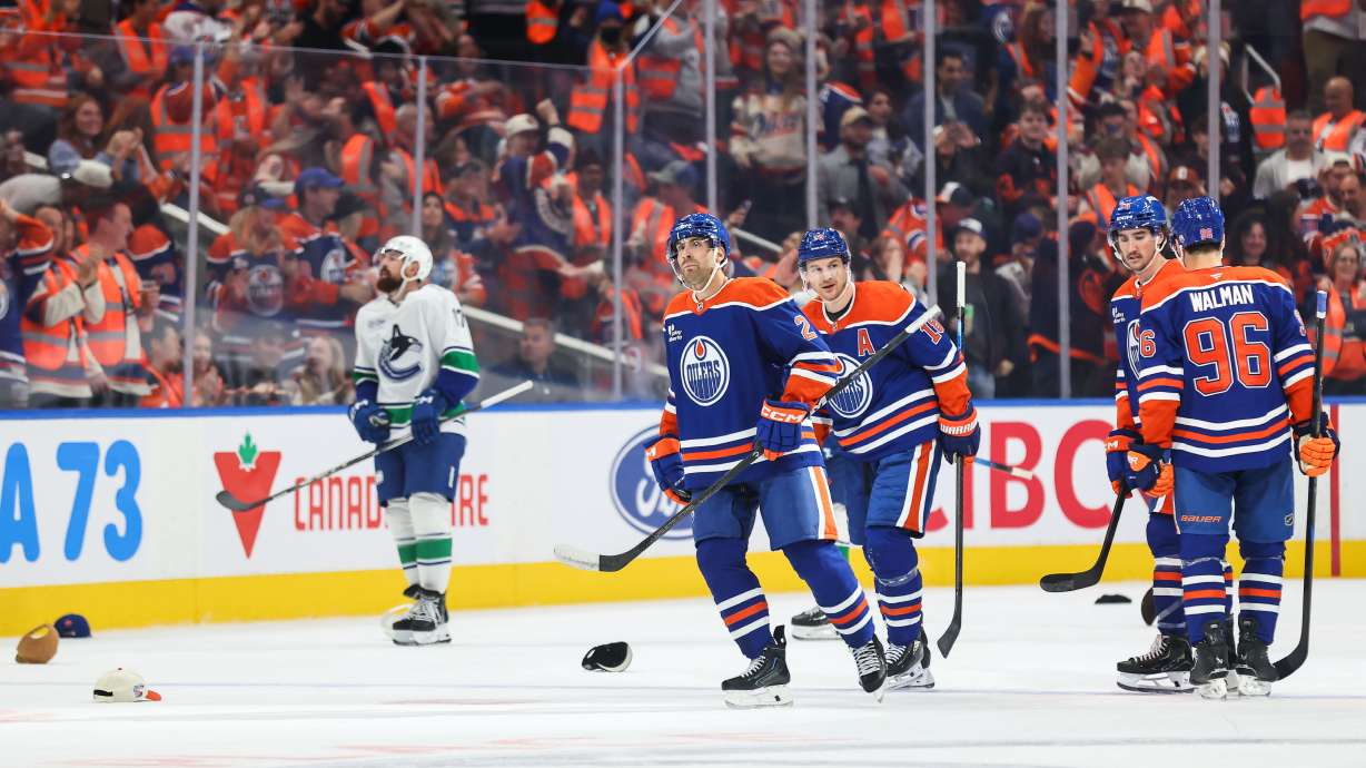 Edmonton Oilers' Evan Bouchard (2) celebrates his hat trick goal against the Vancouver Canucks during third period NHL hockey action in Edmonton on Tuesday, Sept. 29, 2026.