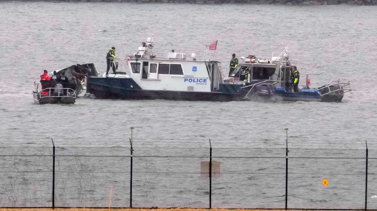 Search efforts are seen around the wreckage site of a deadly midair collision between an American Airlines jet and an Army helicopter in the Potomac River near Ronald Reagan Washington National Airport, Jan. 31, 2025, in Arlington, Va.