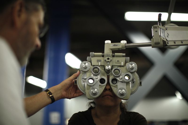 FILE PHOTO: A woman receives an eye exam in Los Angeles September 27, 2012.
