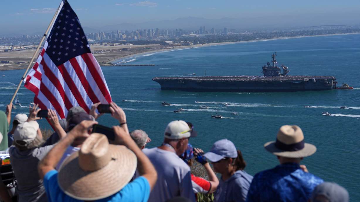 The USS Abraham Lincoln aircraft carrier returns to the San Diego Bay after its record-long deployment, Thursday, in San Diego.
