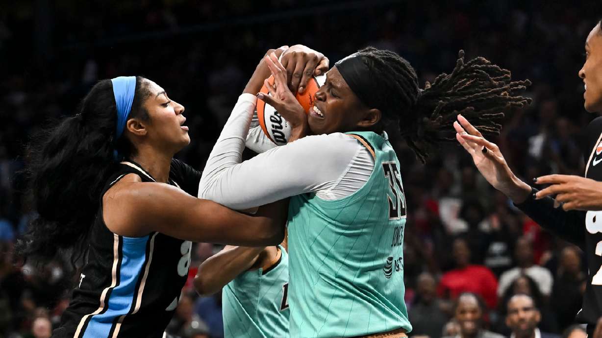 Atlanta Dream forward Angel Reese (5) and New York Liberty center Jonquel Jones (35) fight for a rebound during the second half in Game 2 of the WNBA basketball semifinals, Wednesday, Oct. 7, 2026, in Atlanta.