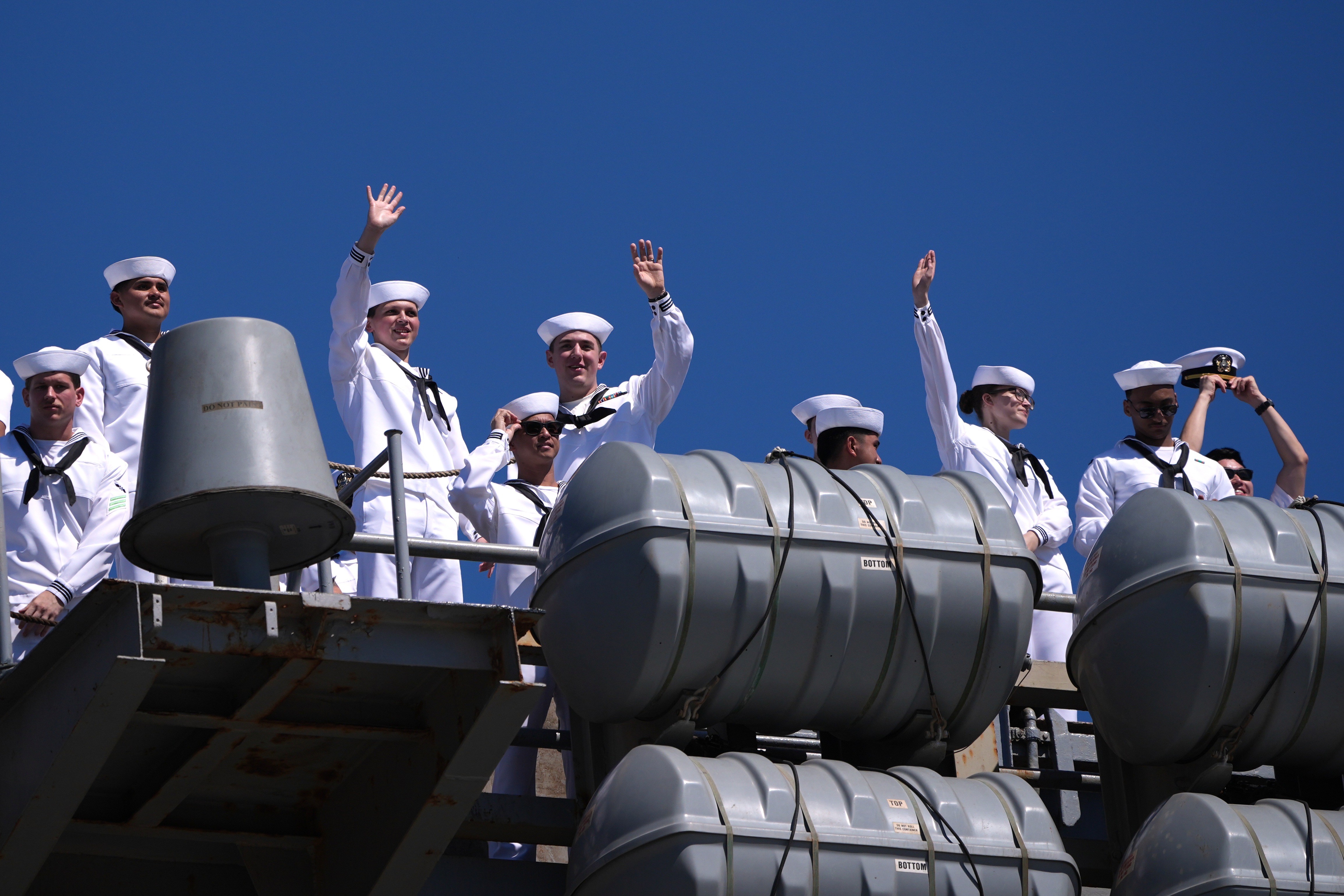 Sailors wave aboard the USS Abraham Lincoln aircraft carrier as it returns to Naval Air Station North Island after its record-long deployment, Thursday, in Coronado, Calif.