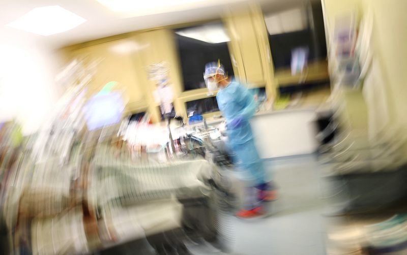 FILE PHOTO: Medical staff looks after patients at a clinic in Darmstadt, Germany, December 12, 2021.