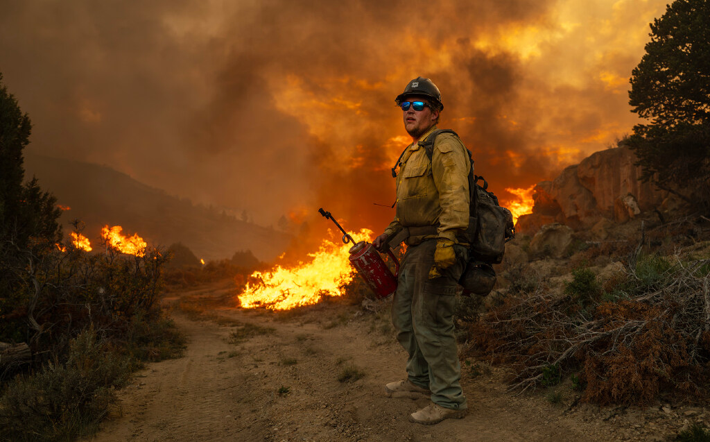 Firefighter Chris Good turns to look up the hillside after using a drip torch to light a fire as the U.S. Forest Service conducts a prescribed burn in the mountains around Kinneys Peak and south of I-70 on Wednesday. Sen. John Curtis, R-Utah, also made a stop to observe the work.